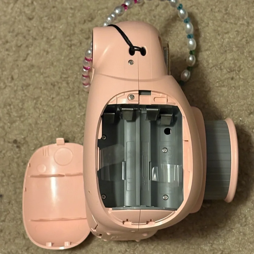NWOT instax mini 7+ pink camera with a beaded lanyard (uses 4 AA batteries)